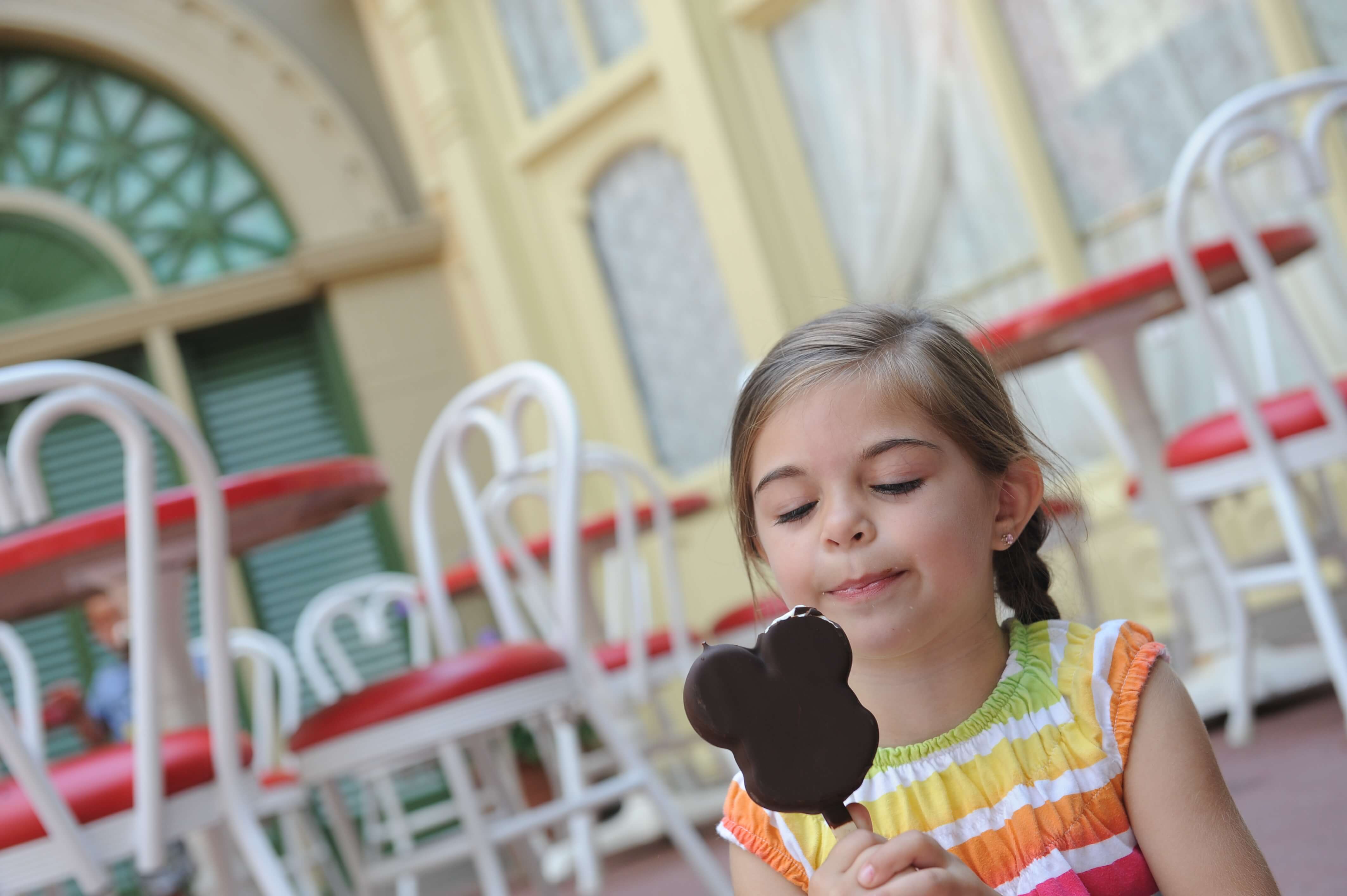 Little girl eating mickey ice cream